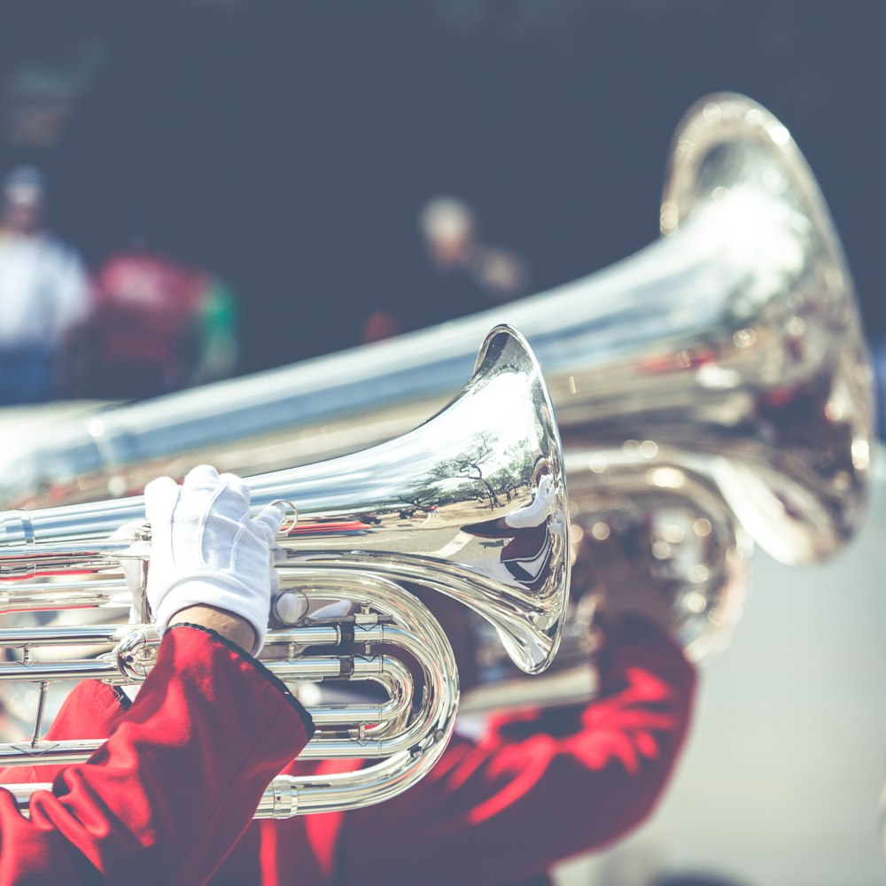 close up photo of person playing horn instrument