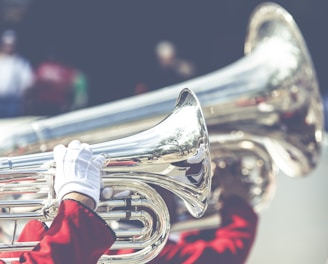 close up photo of person playing horn instrument