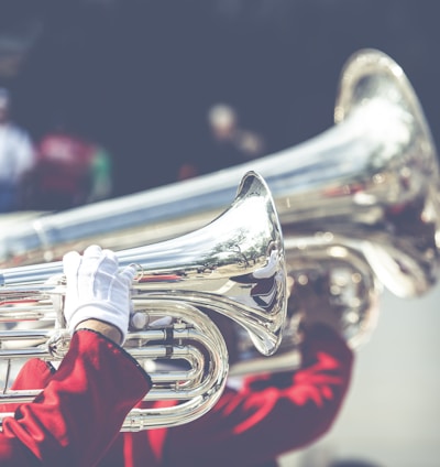 close up photo of person playing horn instrument