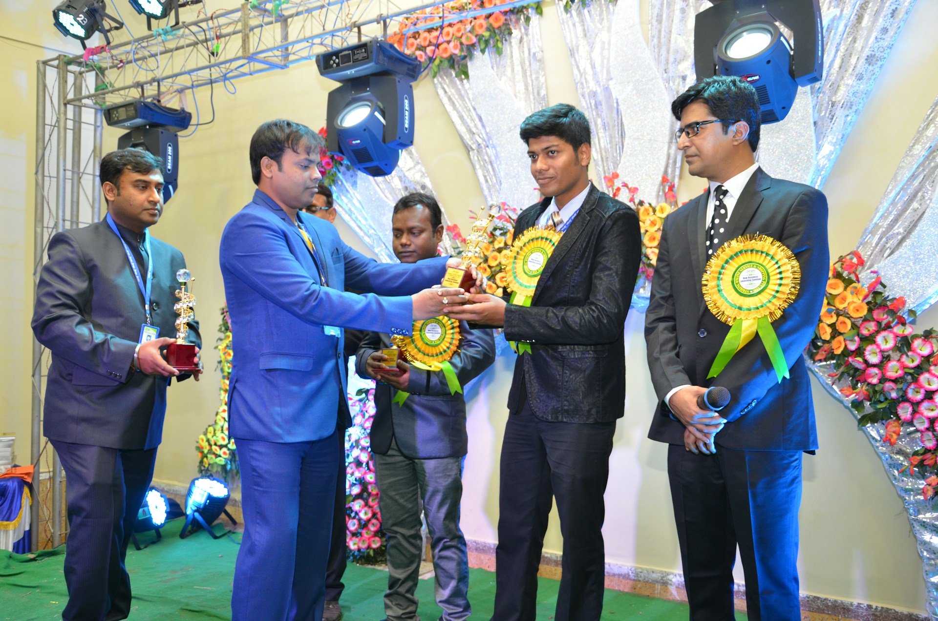 A joyful group of filmmakers and actors celebrating their wins on stage at the BON Awards ceremony.