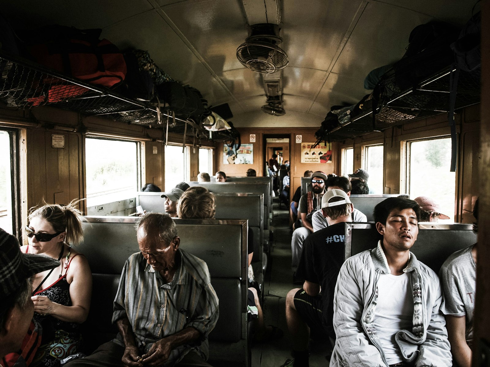 Olympus E-520 (EVOLT E-520) + OLYMPUS 14-42mm Lens sample photo. People sitting inside train photography