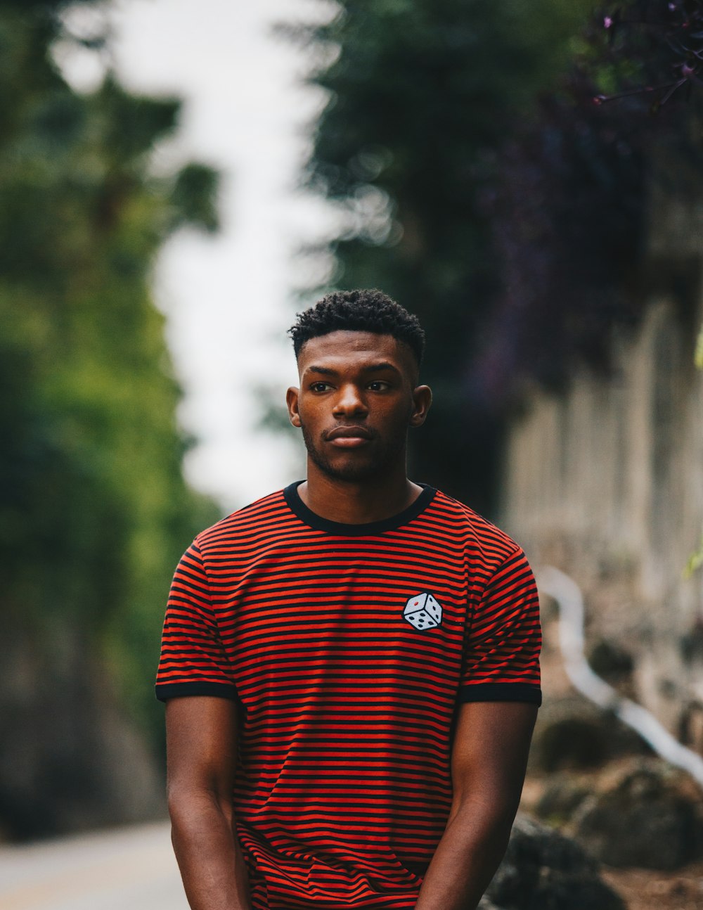 man wearing red and black striped ringer shirt