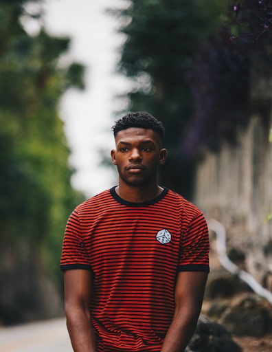 man wearing red and black striped ringer shirt