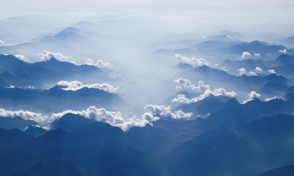 white clouds above silhouette of clouds at day