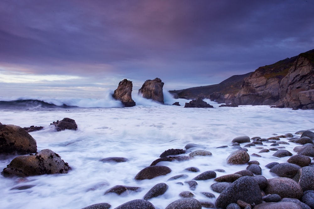 photo of rocky beach during cloudy daytime