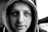 A close-up of a person wearing a bold hoodie.