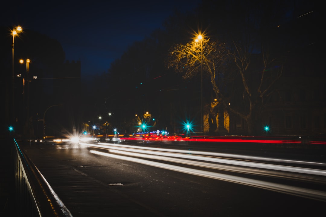 time lapse photography of vehicle passing on road at night