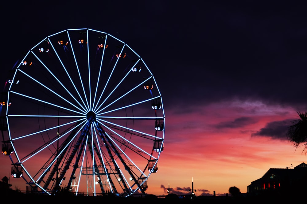 silhouette photography of lit-up ferris wheel during golden hour