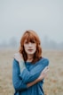 woman in blue raglan shirt shallow focus photography