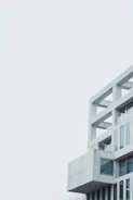 Completed minimalist building with large windows and gray facade.