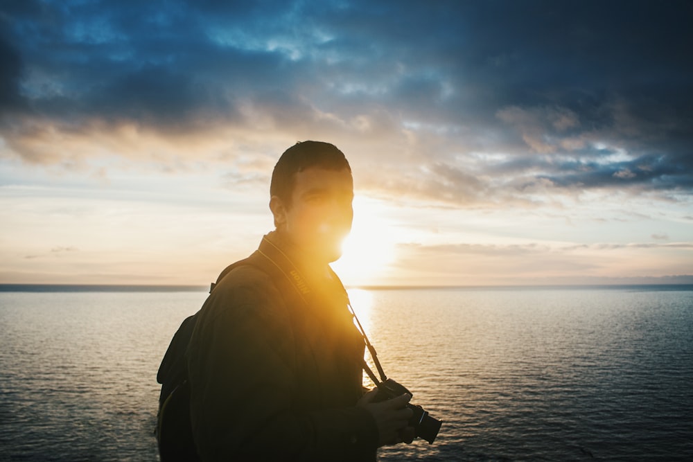 man standing near body of water during daytime