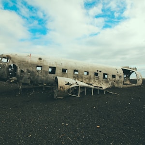 photo of abandoned plane under blue cloudy sky