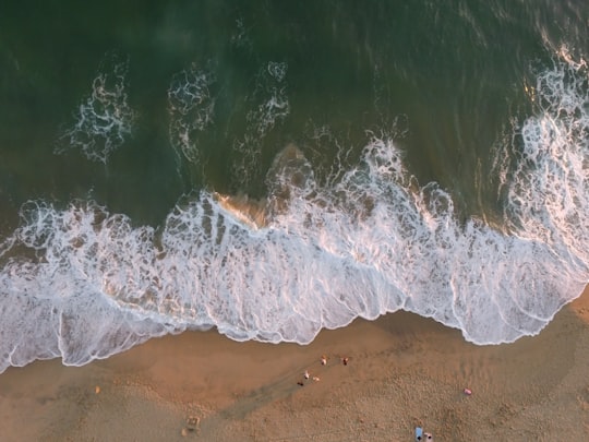 aerial photo of people on seashore during daytime in Huntington Beach United States