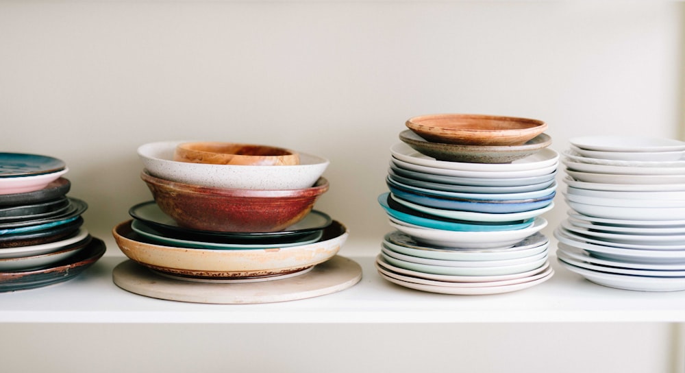 assorted-color ceramic plates and saucers