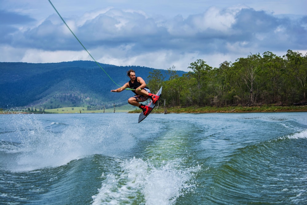 man playing wakeboard during daytime