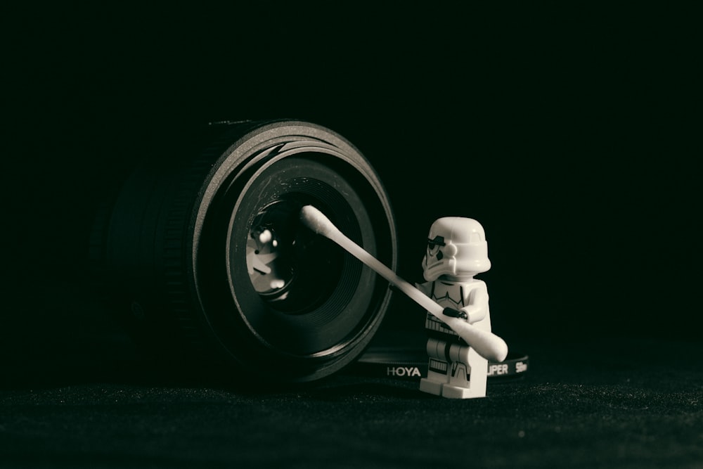 Star Wars Storm Trooper minifig holding cotton swab cleaning camera lens