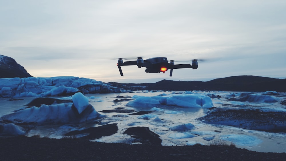 drone flying on body of water