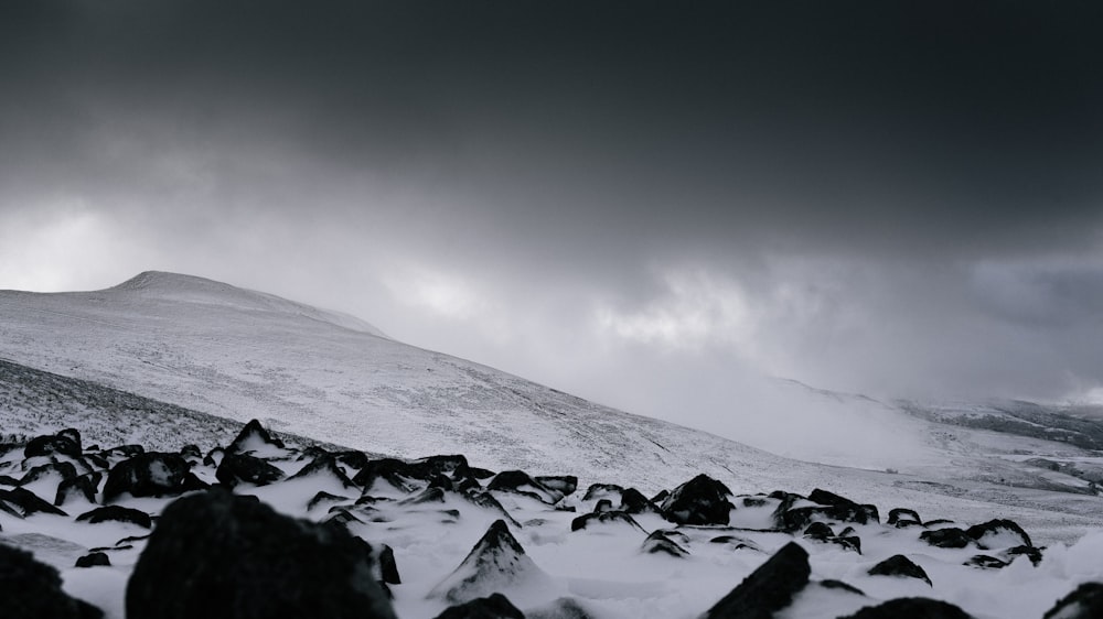 snow covered mountain under gray clouds at daytime