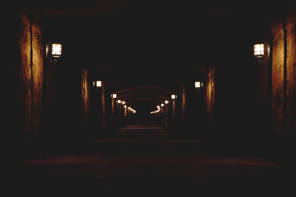 concrete hallway with lighted wall lamps