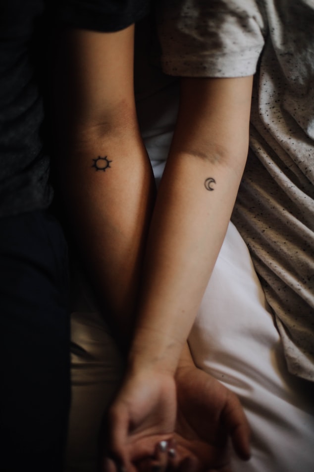 A couple with sun and moon tattoos