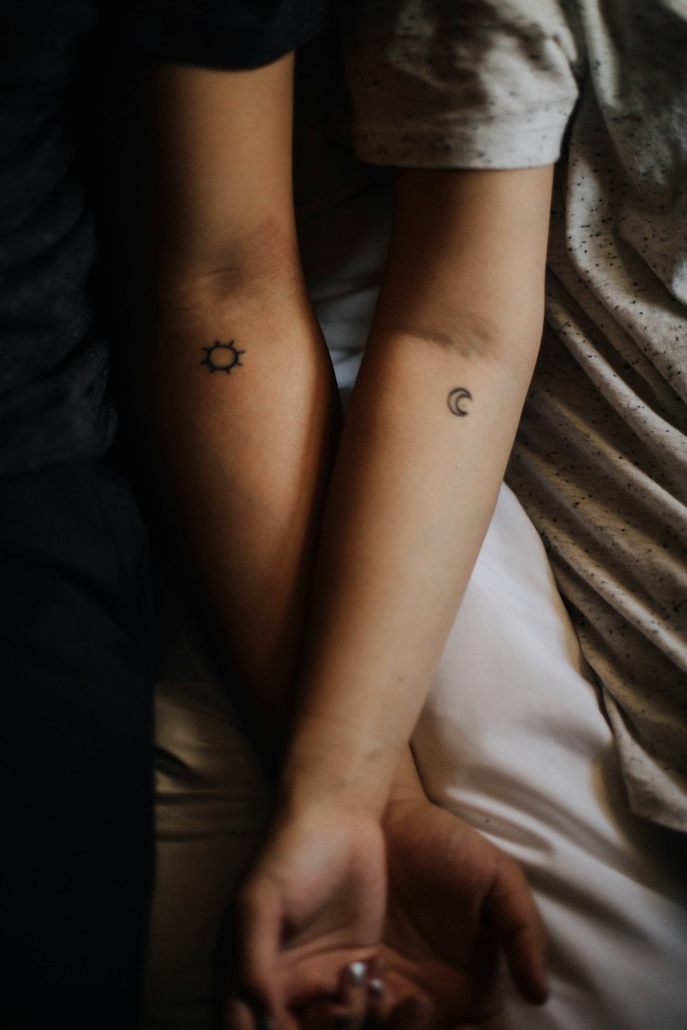 two persons showing their hand tattoos