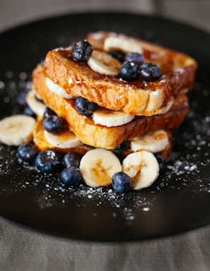food photography,how to photograph if you use this photo send me a link and i’ll help share your content. or tag me or hashtag me if you’d like at #miralcetwentyone | www.miracletwentyone.org; toast bread with blueberry on black plate