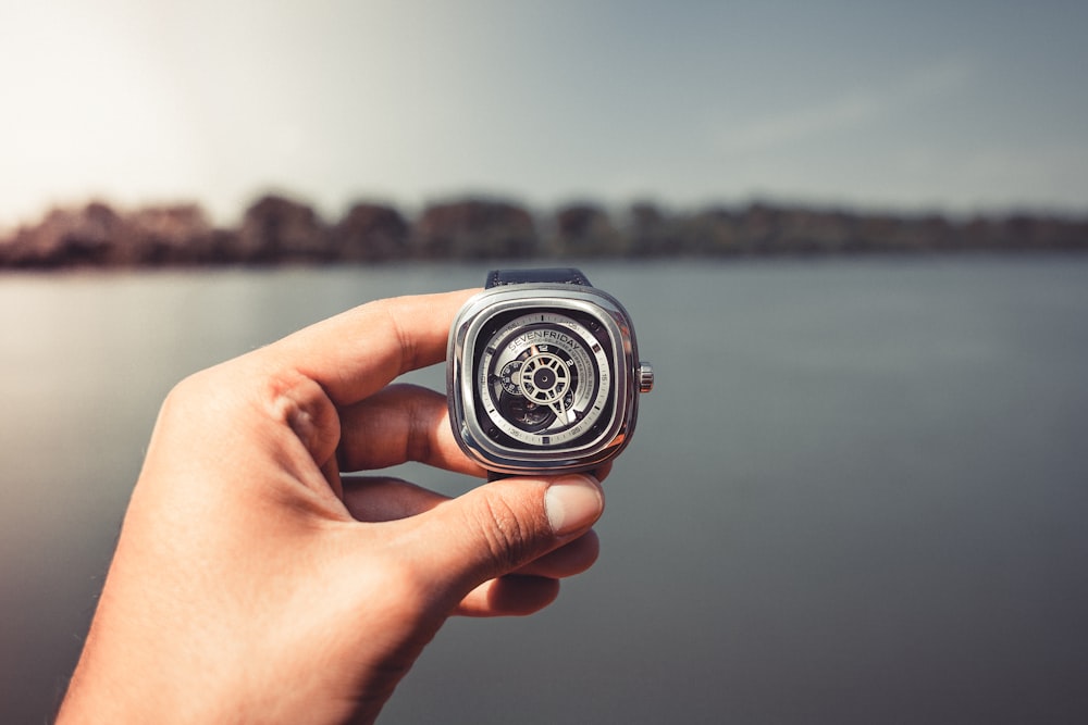 person holding wristwatch