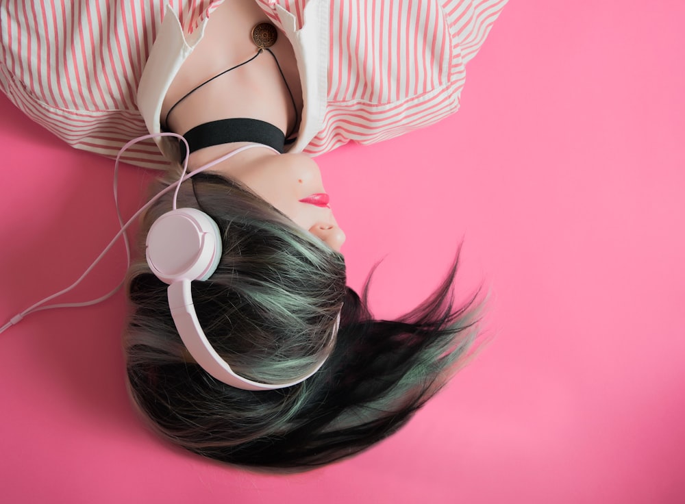 woman covering her hair and wearing headphones