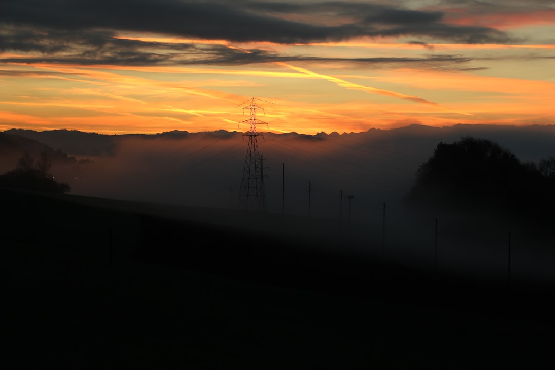 gray metal tower behind white mist at daytime