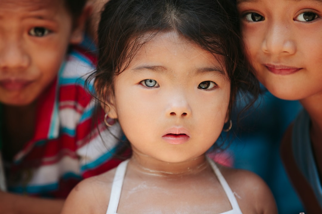 girl standing beside children