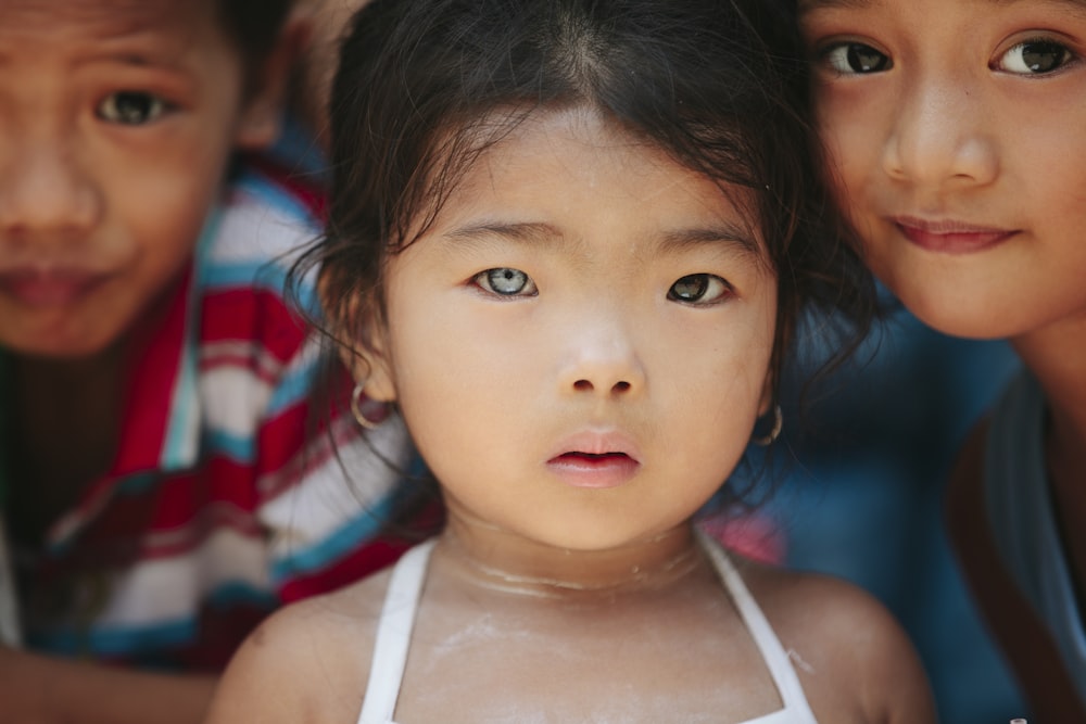 girl standing beside children