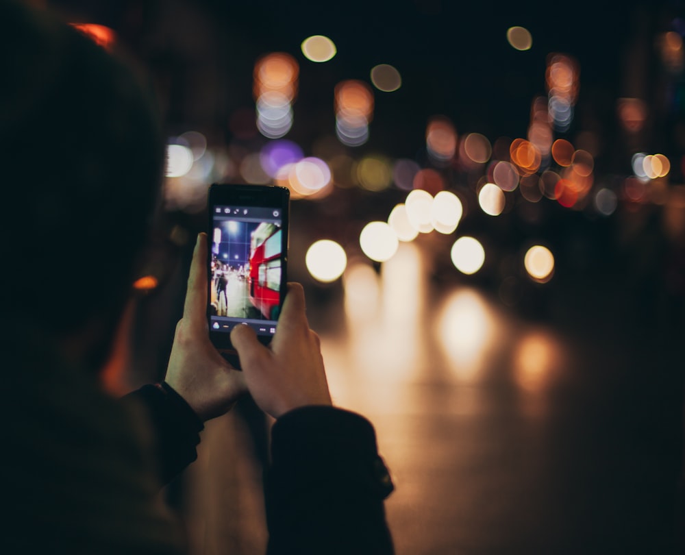 person holding black Android smartphone