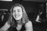 A teenager smiling confidently while talking openly in a supportive group session.