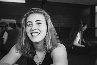 A teenager smiling confidently while talking openly in a supportive group session.