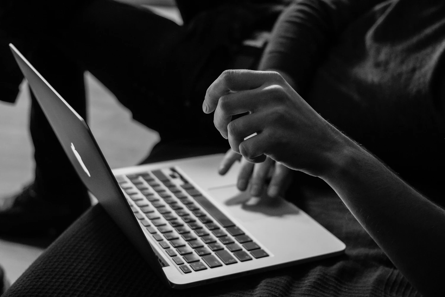 Black and white close-up of consulting work on a laptop
