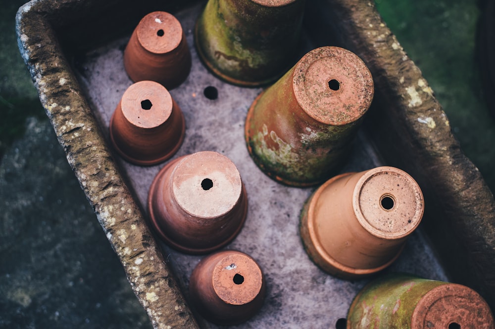 brown clay pot on concrete surface