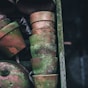 brown-and-green moss covered stacked clay pots