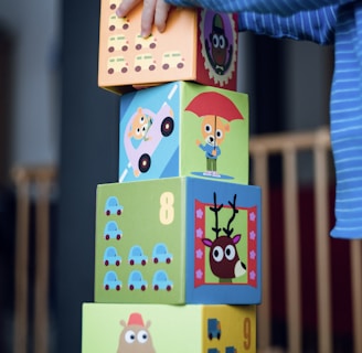 child building an four boxes