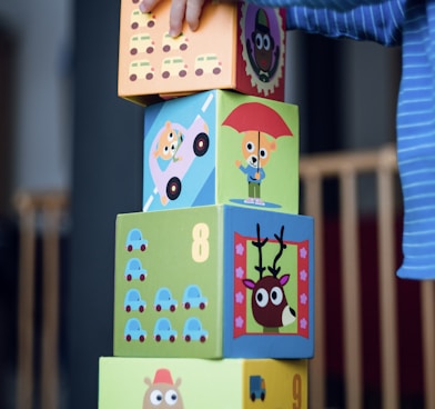 child building an four boxes