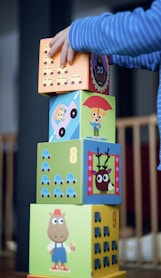 child building an four boxes