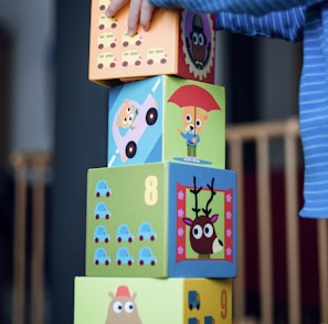 child building an four boxes