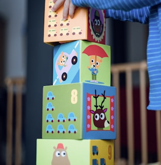 child building an four boxes