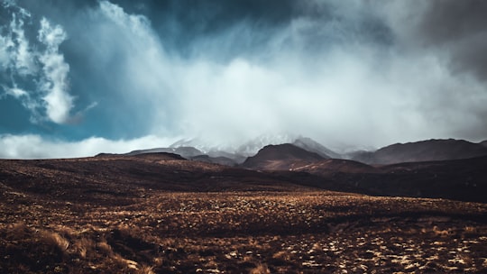 photo of mountains near on soil pavement in Tongariro National Park New Zealand