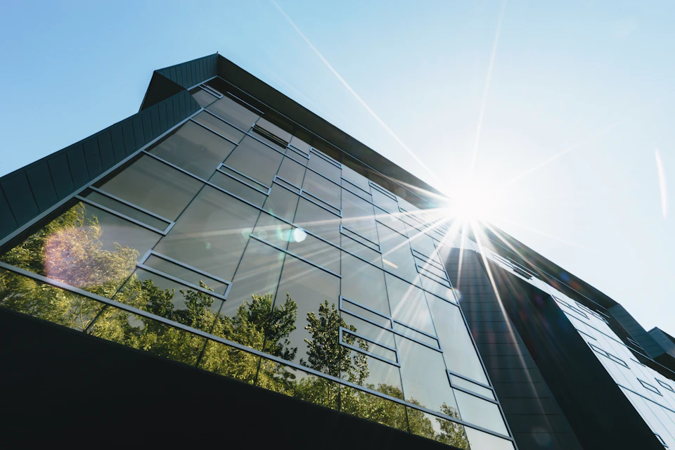 Modern commercial building with glass facades and architectural landscaping