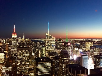 A sleek city skyline at dusk with shimmering lights symbolizing growth and ambition.