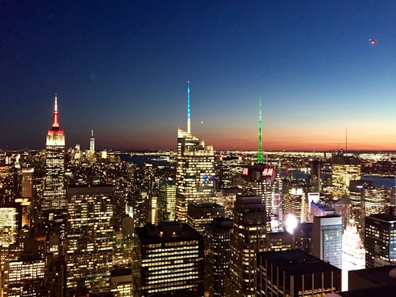 A vibrant city skyline at dusk with glowing wireless signals connecting buildings.