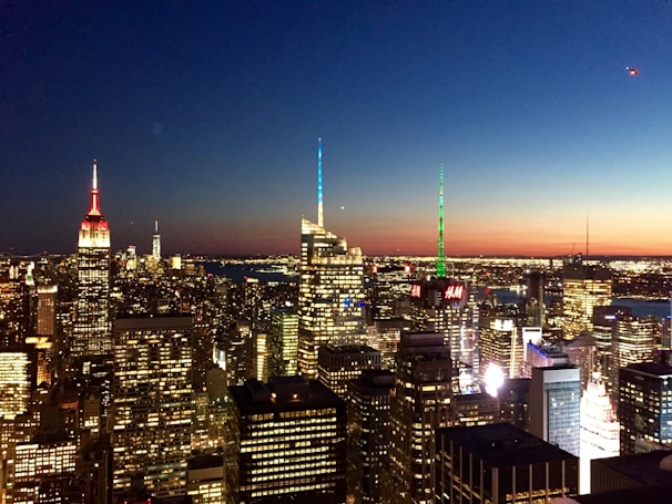 A sleek city skyline at dusk with shimmering lights symbolizing growth and ambition.