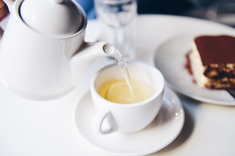white ceramic teapot and teacup