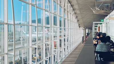 Project managers reviewing blueprints inside a modern airport terminal under construction.
