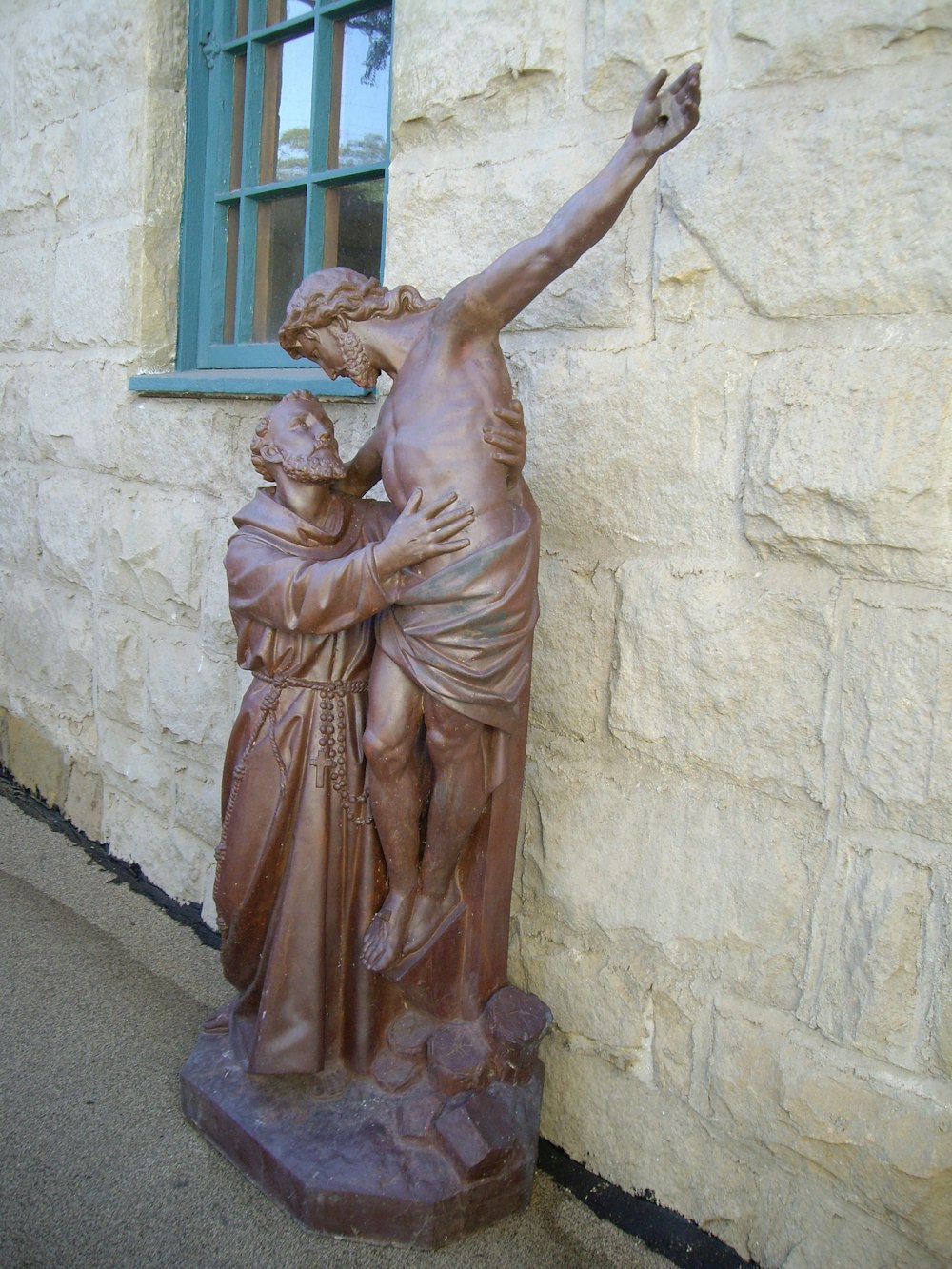 A statue outside of a church.